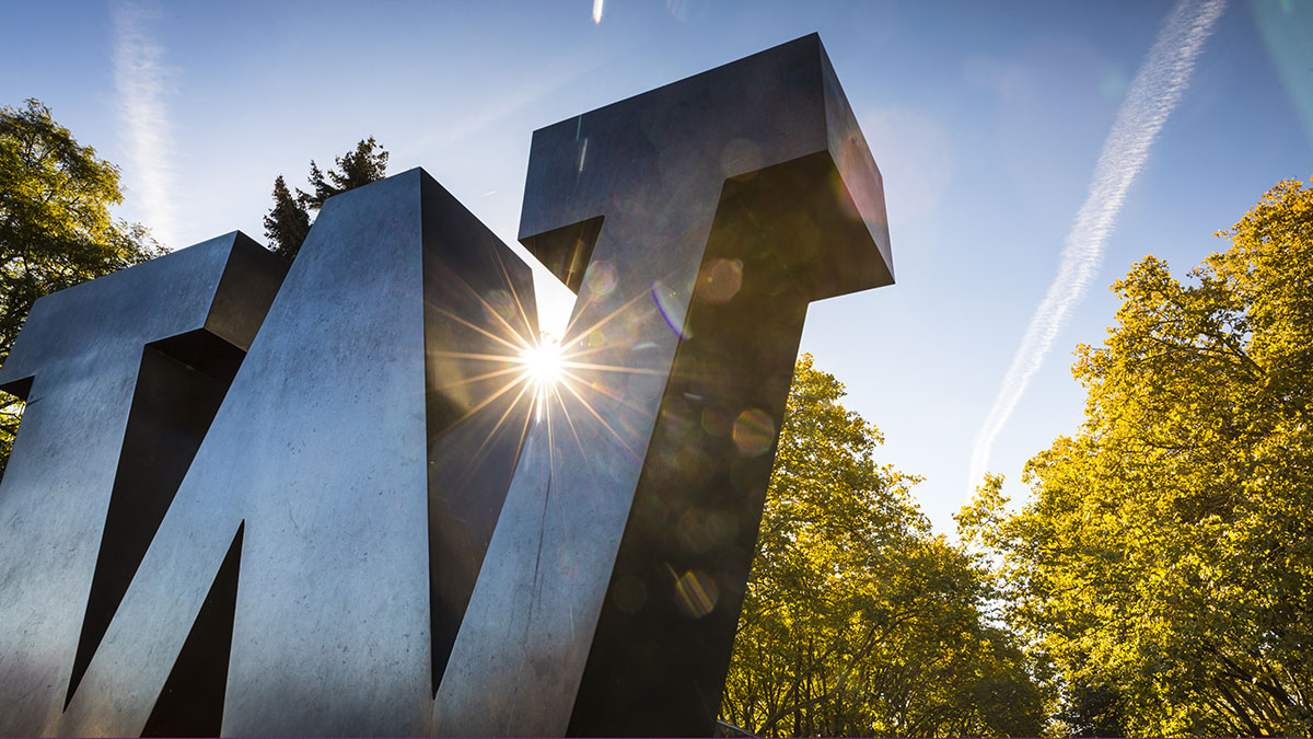 A metal "W" sculpture shines in the sun on the main UW campus. 